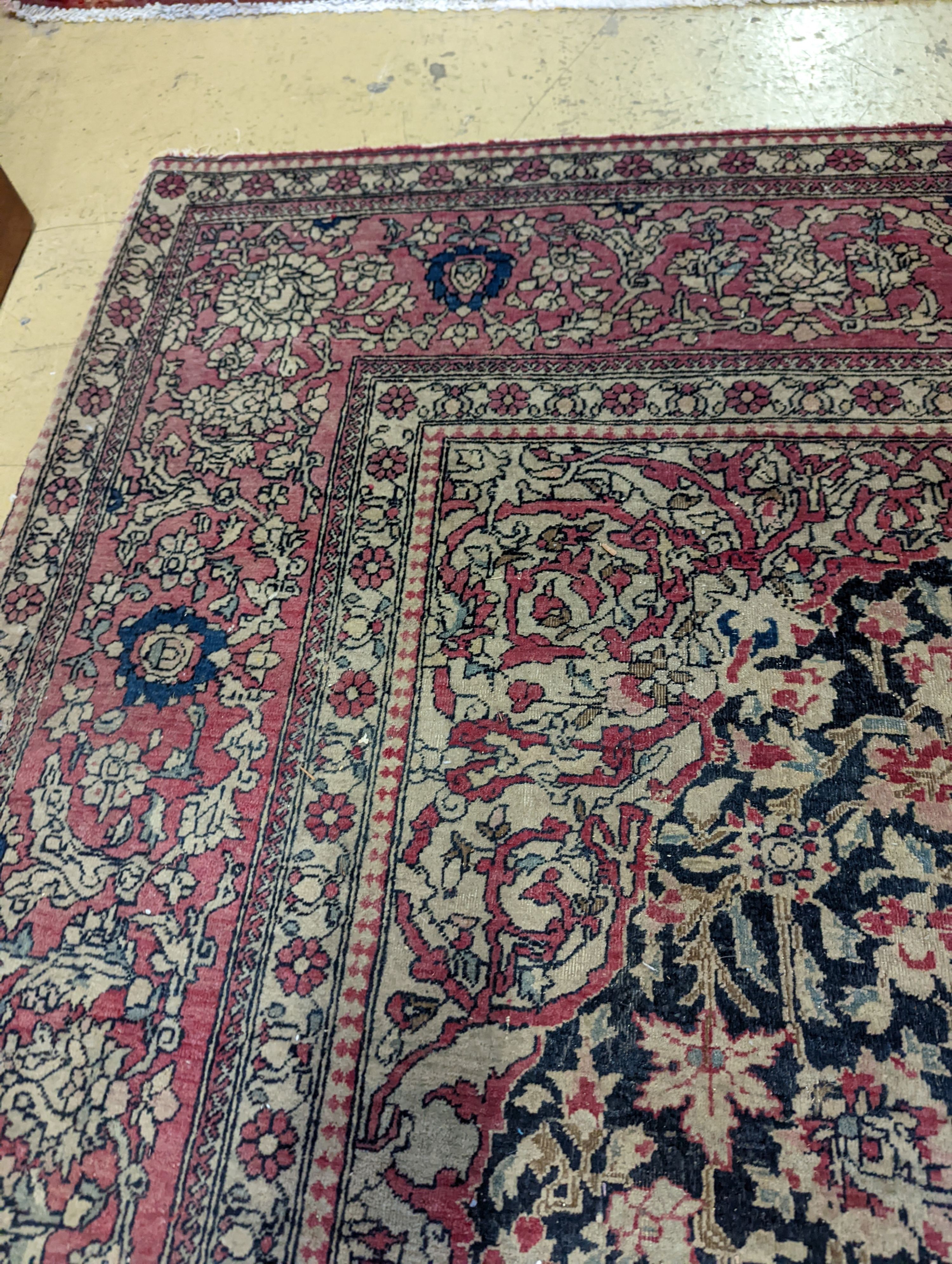 An Isphahan black ground rug with central foliate medallion, mulit-bordered, 202 x140cm